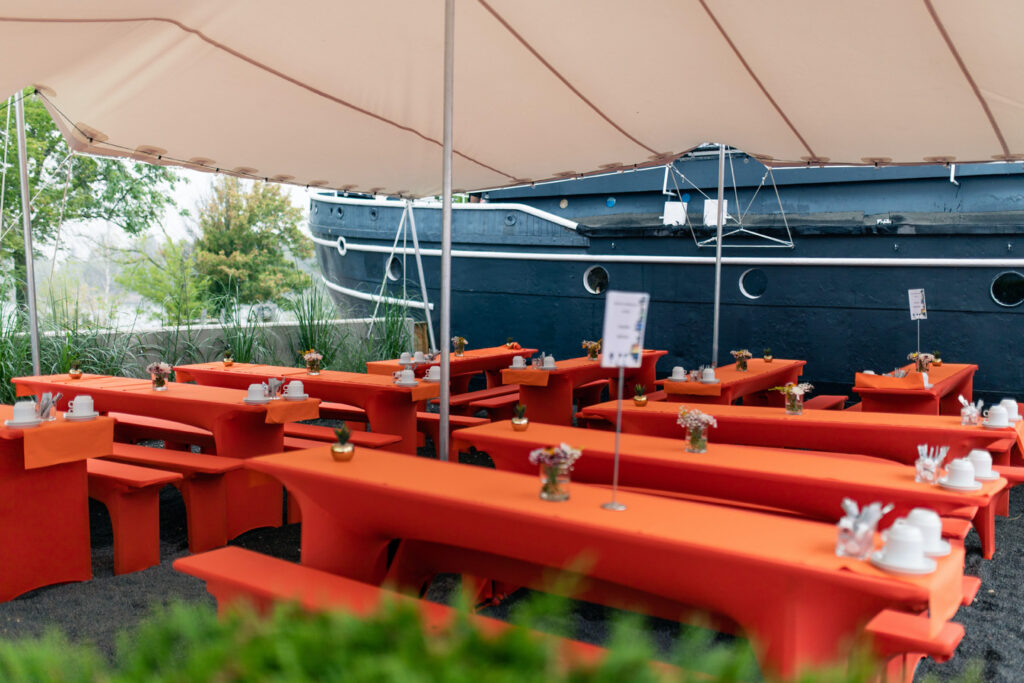 Für den Schulanfang ist der Außenbereich vor dem Bug mit Biertischgarnituren und bunten Hussen bestuhlt.